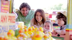 Children winning prize at amusement park Stock Footage