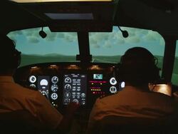 MS rear internal view of pilots and instrument panel in professional flight simulator during landing, RED R3D 4K Stock Footage