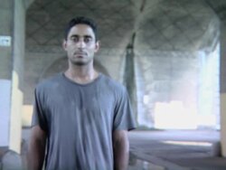 Dark, Handsome Young Man Standing Under Arched Bridge Stock Footage