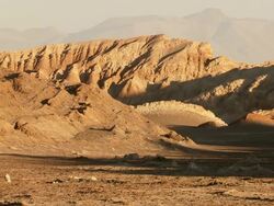WS View of Desert and Cyclist riding / San Pedro de Atacama, Norte Grande, Chile Stock Footage