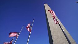 Washington Monument and american flags in DC USA Stock Footage