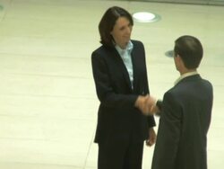 Male and female meet and shake hands; UK Stock Footage