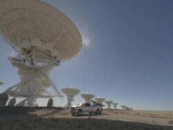 WS DS View of satellite dishes and truck moving behind them / San Augustine, New Mexico, USA  Stock Footage