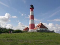 WS LA View of Westerhever lighthouse from grass field / Westerhever, Schleswig Holstein, Germany Stock Footage