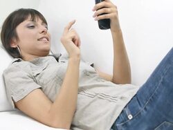 Young woman typing SMS on smart mobile phone Stock Footage