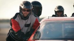 Pit-crew team pushes race-car Stock Footage