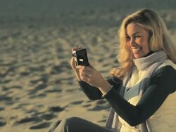 Woman on beach using video camera Stock Footage