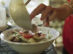 MS SLO MO  Bowls beign added more meat and garnishwith vegitables / Vang Vieng, Vientiane, Laos Stock Footage