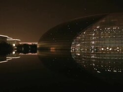 WS PAN Great Hall of the People next to National Grand Theater reflecting at lake at night / Beijing, China Stock Footage