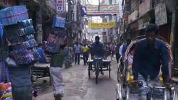 The crowded alleyways and streets of the old part of Dhaka Bangladesh are bustling with pedestrians and rickshaws Stock Footage