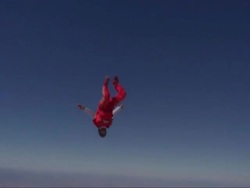 Skydiver exits plane and does a series of flips, spins, tricks, and then deploys parachute. Stock Footage