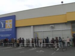 Aftermath of tsunami after magnitude 9 Tohoku earthquake, north east Japan, March 2011. People queue up outside shop in Osaki city Stock Footage