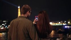 A couple takes photos of the Eiffel Tower. Stock Footage