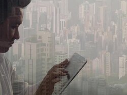 Composite image of man using tablet device and city Stock Footage