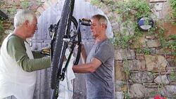 Senior Men Repairing a Bicycle Stock Footage