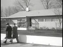 1953: LEVITTOWN, PENNSYLVANIA: FIRST MODEL HOME: Sign in yard 'Levittowner', VS People walking sidewalk, some entering model home. ( Single level, 3 bedroom, 1 bath, 5 styles) Instructional Video