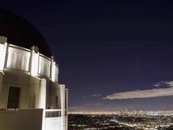 T/L WS Griffith Observatory dome with Los Angeles illuminated at night in distance / California, USA Stock Footage