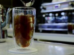 CU Pouring coffee into ice water cup / Jeju, Jeju-do, South Korea Stock Footage