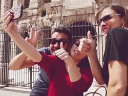 Tourists in Rome taking a selfie by Coliseum Stock Footage