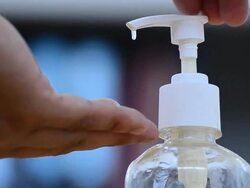 Hand pushing top of liquid soap dispenser Stock Footage