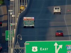 Ambulance driving down a multi-lane highway Stock Footage