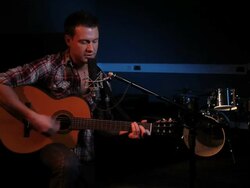 Female playing guitar and singing in recording studio Stock Footage