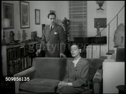 1946: SUCCESSFUL COUPLE: DRAMATIZATION: NIGHT: EXT Urban apartment building. Couple (30s,40s) in upscale living room SOT wouldn't get on each other's nerves if they had a child, husband saying why not adopt one. Instructional Video