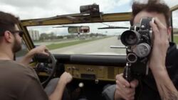 Young man documents road trip with vintage film camera Stock Footage