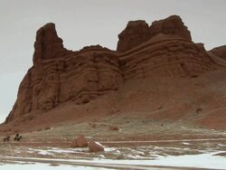 WS Three cowboys galloping on horses in front of red rock landscape / Shell, Wyoming, United States Stock Footage