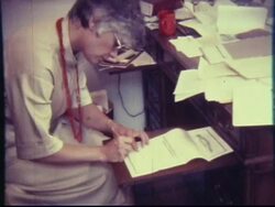 1970s Woman Signs Important, Legal Documents (from 8mm film camera) Stock Footage