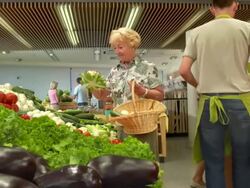 HD DOLLY: Senior Woman Picking Up Vegetables Stock Footage
