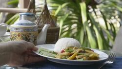 Being serve dish of fried chicken with curry souce and vegetables on rice Stock Footage