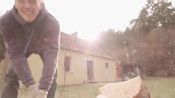 Slow motion:Splitting Wood With An Axe with sun background Stock Footage