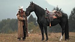 SLO MO DS Cowgirl stroking horse on neck Stock Footage