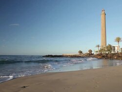 WS View of Maspalomas lighthouse side by beach at sunrise / Maspalomas, Gran Canaria Canary Islands, Spain Stock Footage