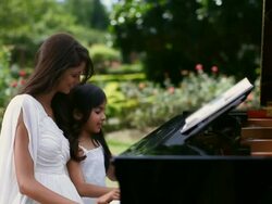 Girl learning piano with the help of her teacher  Stock Footage