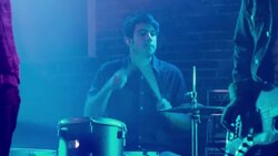 Pan from medium shot of drummer to close up of guitar Stock Footage