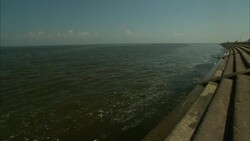 Lake Ponchartrain waters are contained by a concrete levee. Stock Footage
