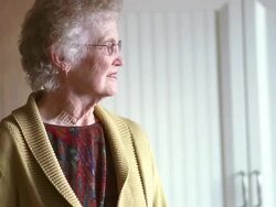MS Senior woman wearing eye glasses and looking around room / Washington State, USA Stock Footage