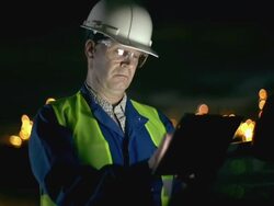 Engineer with tablet at industrial, oil or gas plant Stock Footage