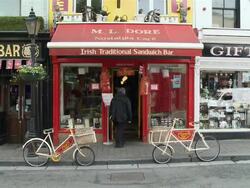 MS Shops at high street with old bicycles / Kilkenny, County Kilkenny, Ireland Stock Footage