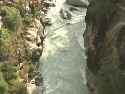 Tilt up flowing stream between mountains gomukh uttarakhand Stock Footage