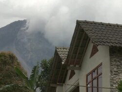 Merapi volcano steams with house close by in foreground; Central Java, Indonesia. 28 October 2010 Stock Footage