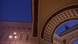 A couple walks beneath the beautiful arches of a massive building. Stock Footage