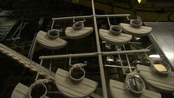 Meat grinding equipment hangs from racks in a factory. Stock Footage