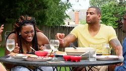 MS Smiling woman in discussion with friends during backyard party Stock Footage