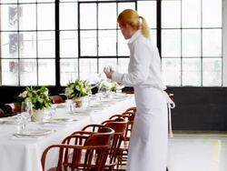 MS waitresses setting banquet table for dinner party in loft Stock Footage