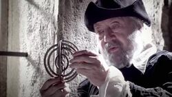 Nostradamus examines a gyroscope in the light of a window. Stock Footage