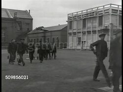 1946: FRANCE COAL PRODUCTION: WS Coal factory, train. WS French factory workers exiting factory buildings. HA WS Crowd of miners, communist leader Maurice Thorez at podium. LA WS Thorez talking at podium. HA WS Crowd clapping, cheering. Instructional Video