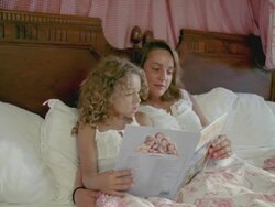 MS, Teenage girl (16-17) with sister (6-7) reading book in bed, Saint Ferme, Gironde, France Stock Footage